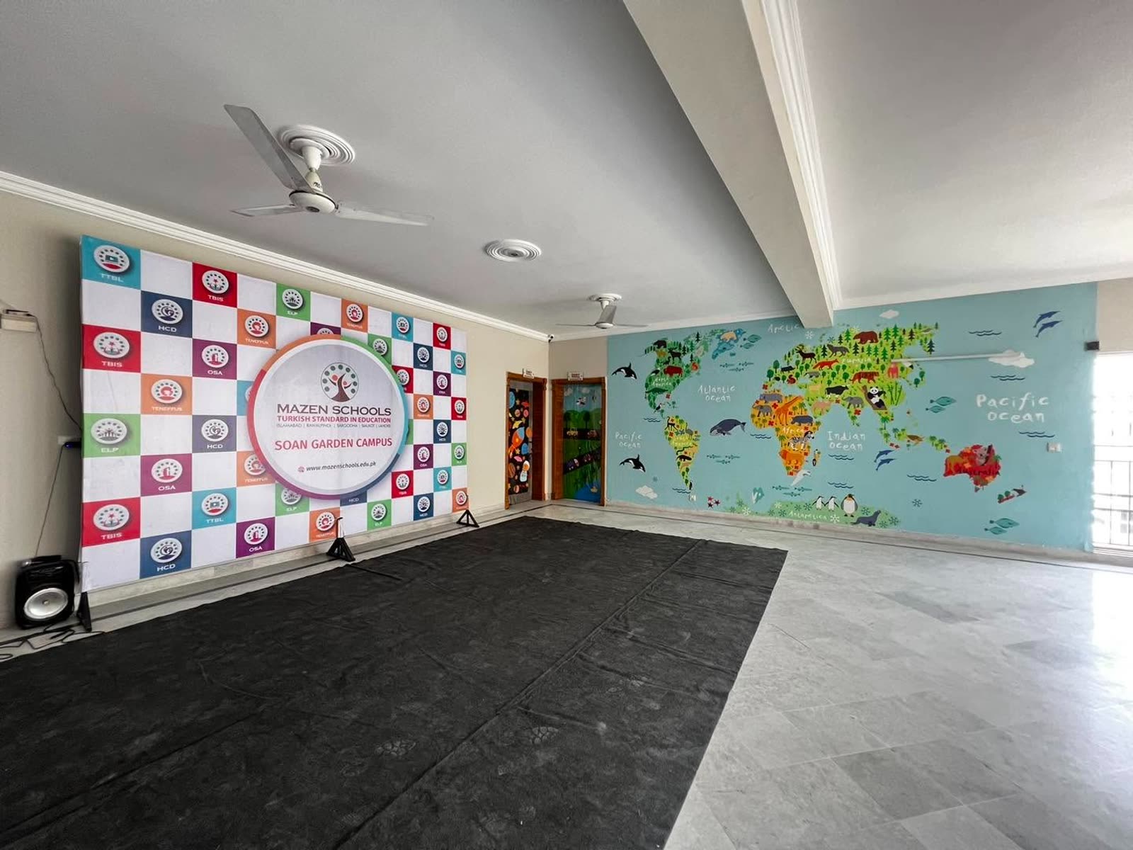 Multipurpose activity hall with world map mural at Soan Garden Campus