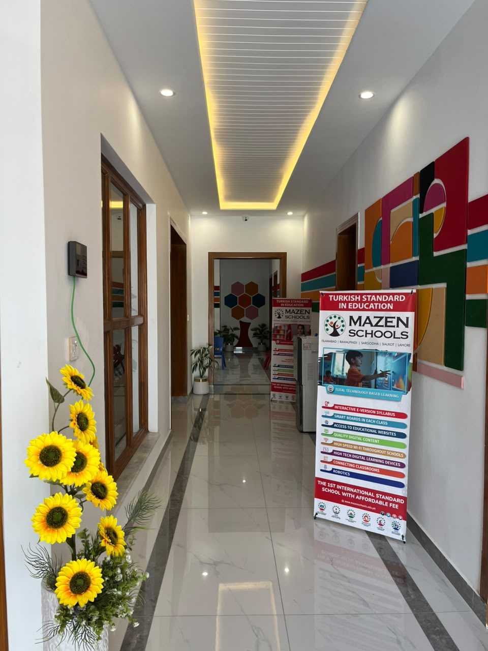 Bright corridor with Mazen Schools banners at B-17 Campus