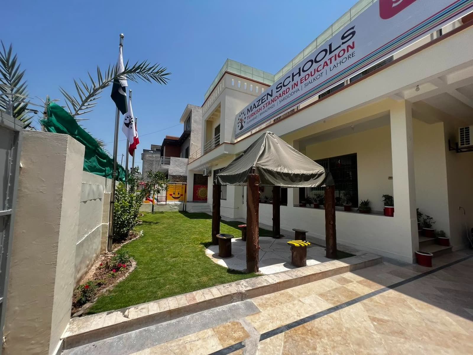 Landscaped courtyard with flags and shaded seating at Soan Garden Campus