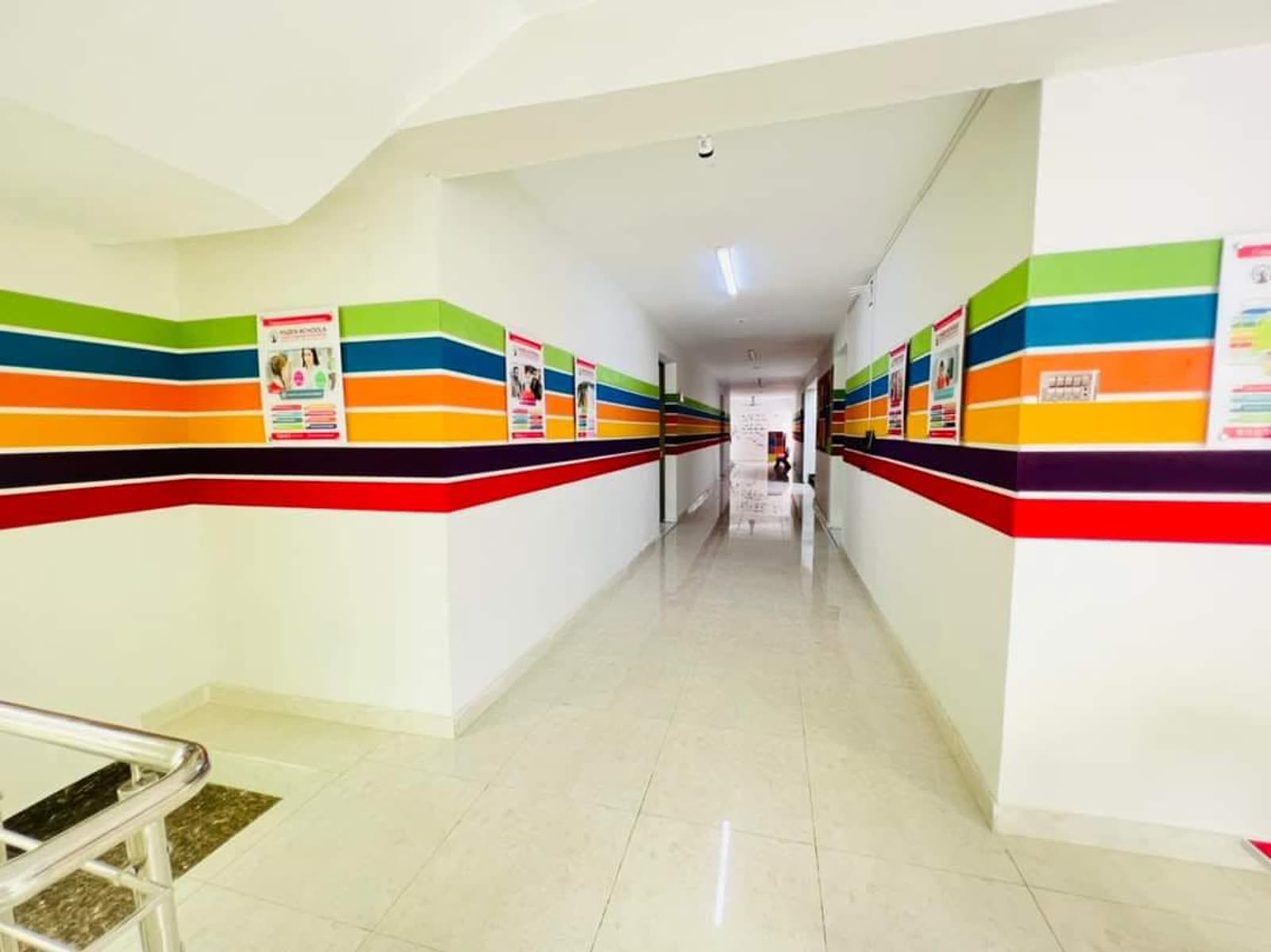 Bright corridor with colourful banded walls at Quaid Campus