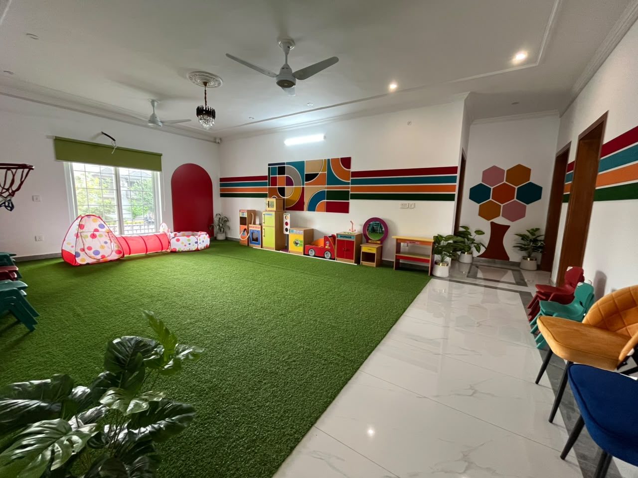 Early years hall with soft play, turf and role-play corner at B-17 Campus