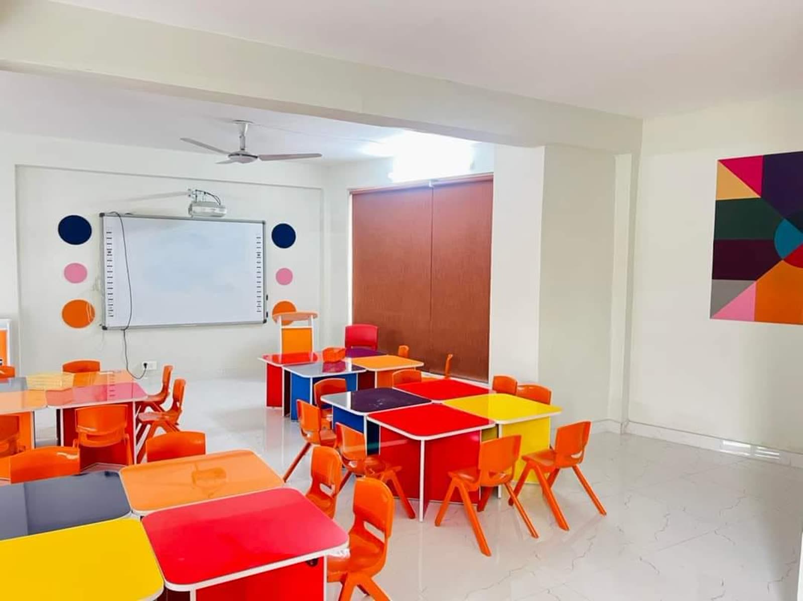 Colourful early years classroom with interactive whiteboard at Quaid Campus